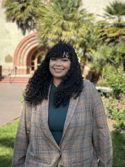 Tyana Meet the Team Student academic success specialist standing outside wearing a blazer.