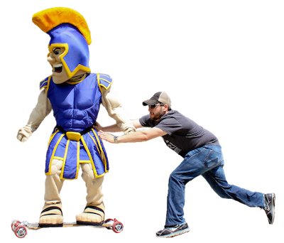 sammy spartan gets pushed on a skateboard
